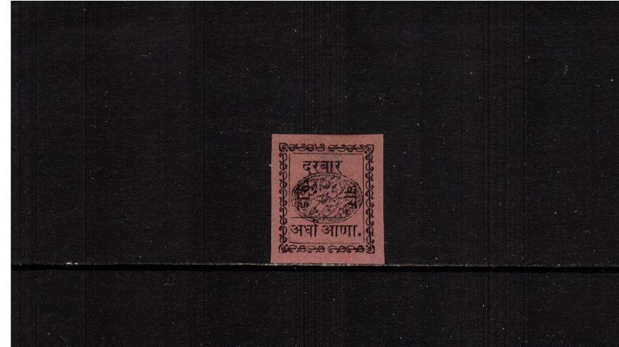 a Black on Magenta mint single with no gum as issued.