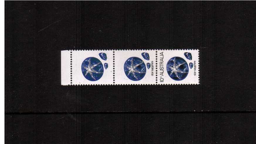 10c Star Sapphire in a top marginal superb unmounted mint vertical strip of three showing ''BLACK OMITTED'' on the marginal stamp and partly omitted on the middle stamp. 
<br/><b>ZAZ</b>
